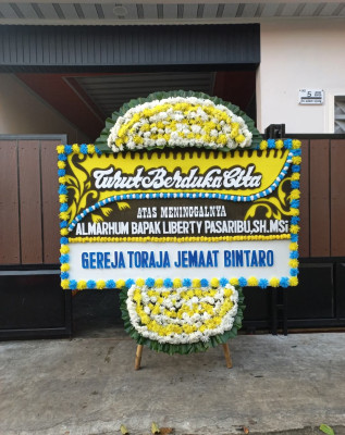 Papan Bunga Duka di Pal Merah